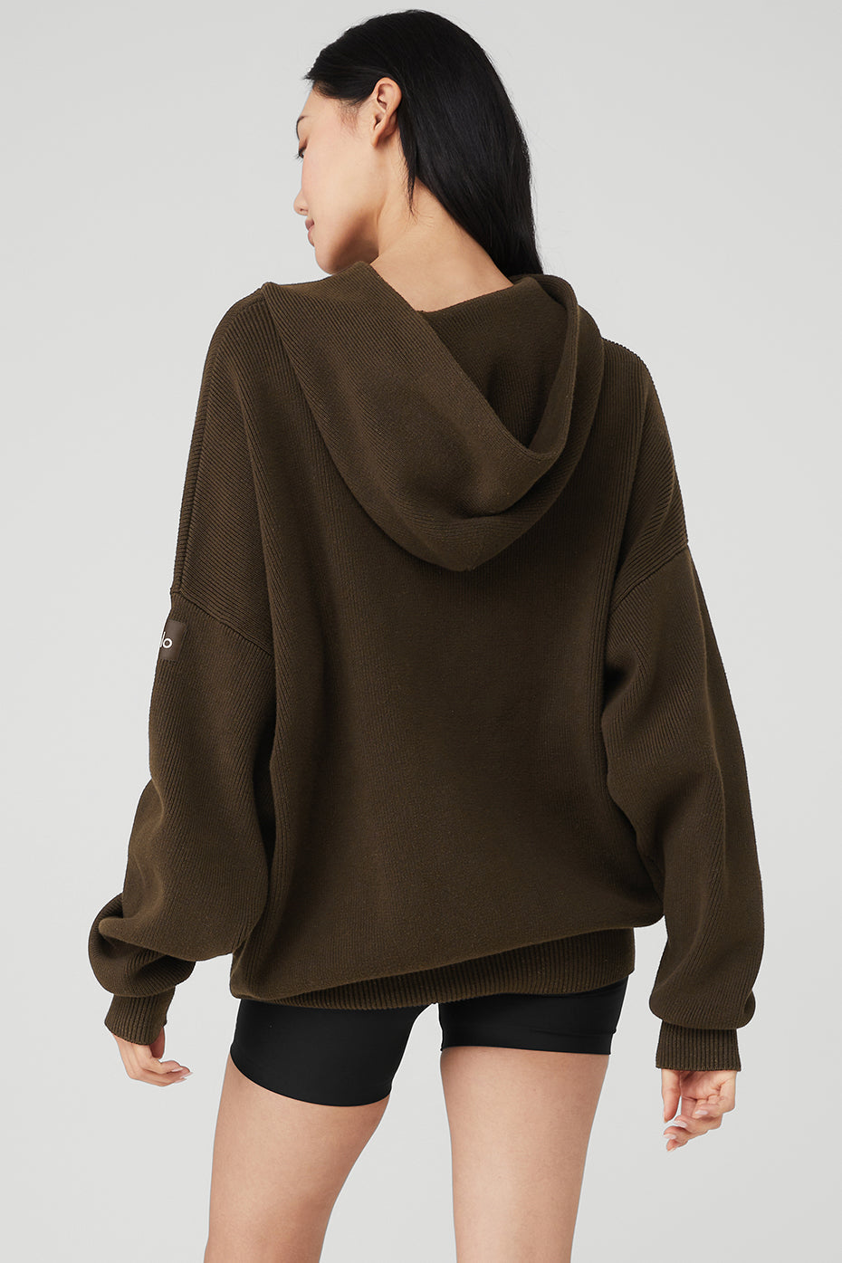 Side angle of the mens hooded pullover sweater, highlighting the ribbed cuffs.