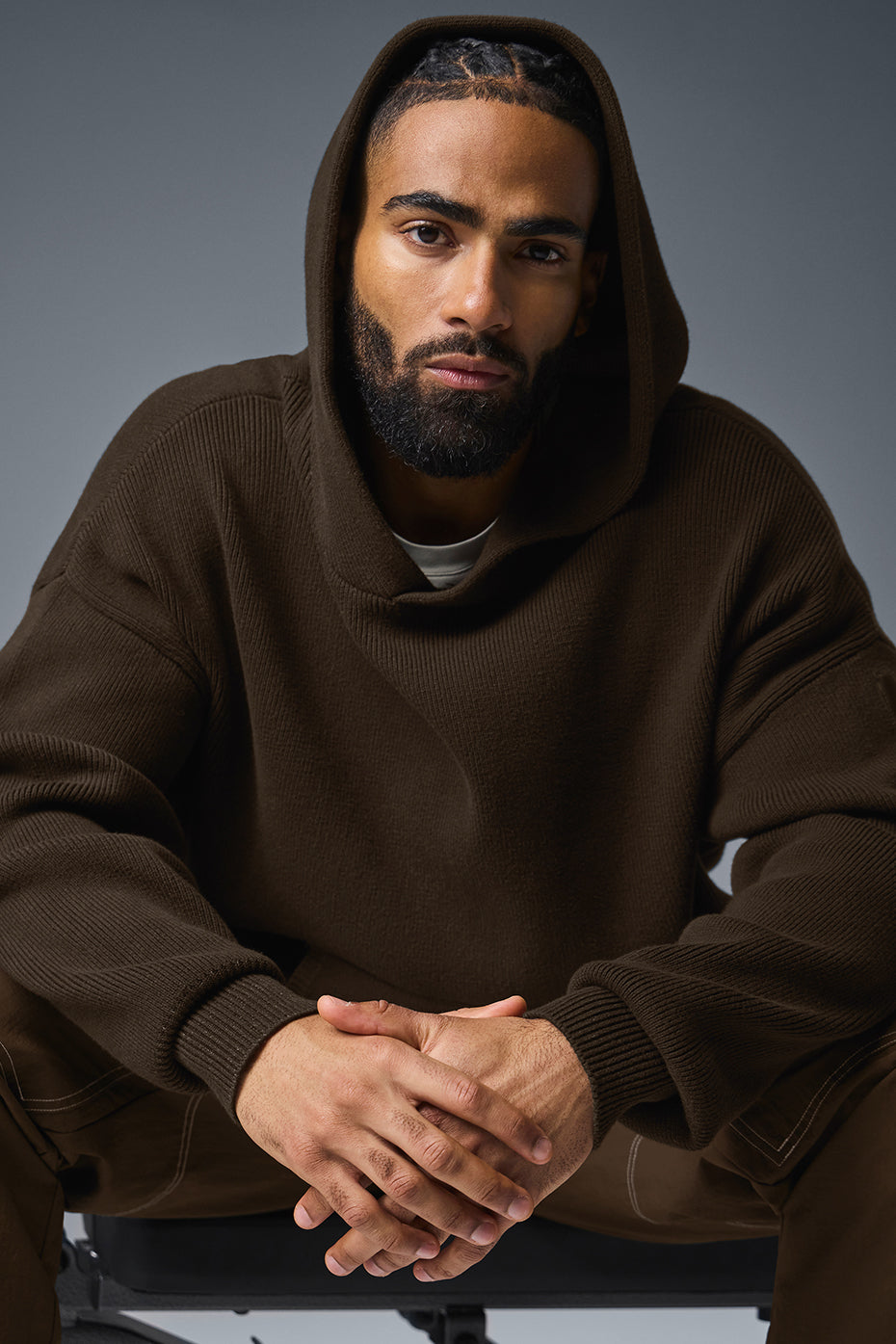 Front view of the unisex sweatshirt with hood and kangaroo pocket in espresso color