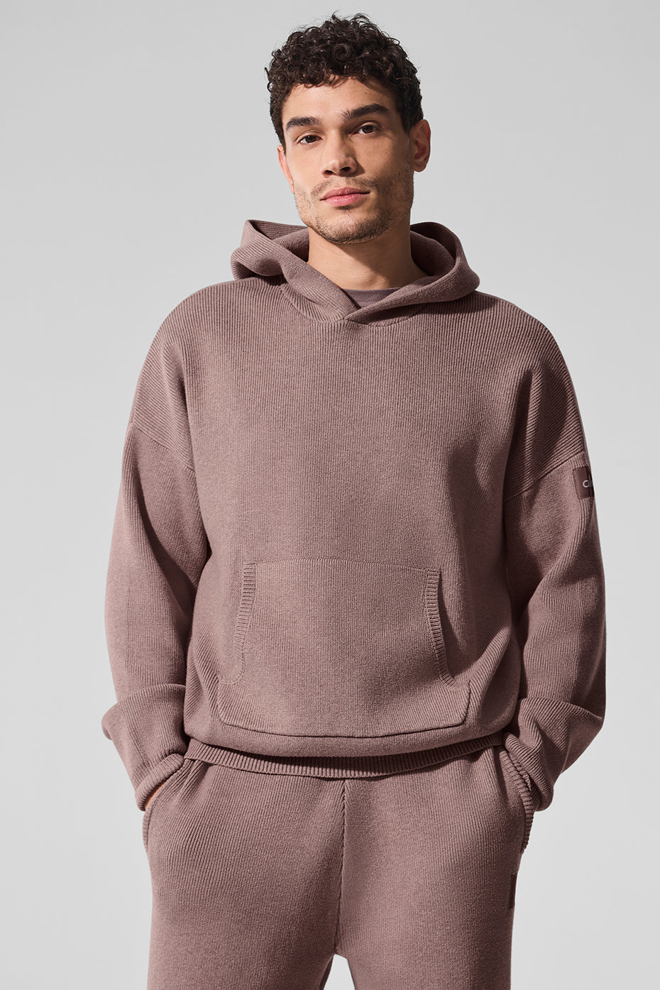 Front view of Lacoste hooded sweater in Mushroom Heather, showcasing the kangaroo pocket.