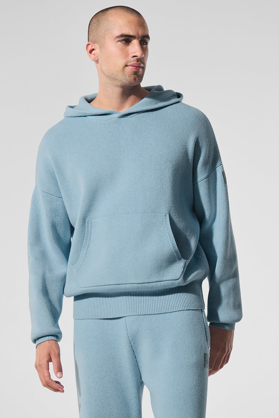 Front view of hooded sweater featuring kangaroo pocket and ribbed cuffs