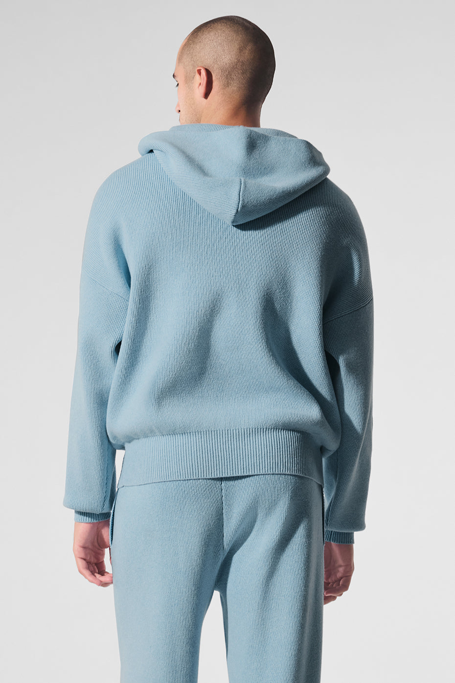 Model wearing cotton hoodie while walking on a crisp city morning