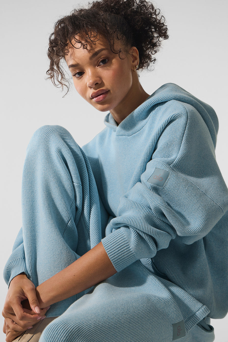 Close-up of navy blue hoodie texture with ribbed cuffs and hem