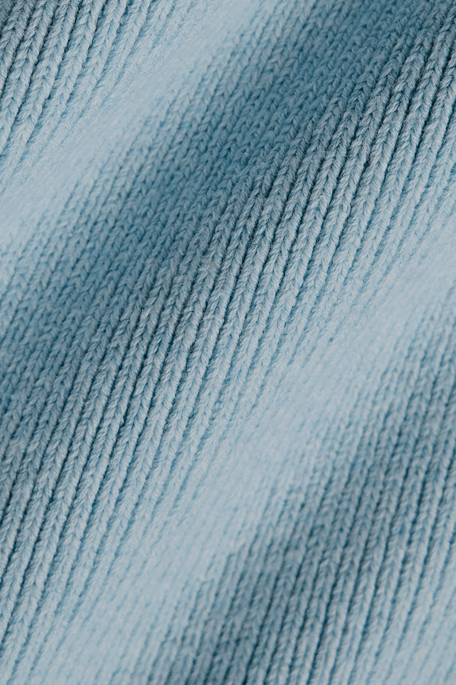 Close-up of navy blue hoodie texture with ribbed cuffs and hem