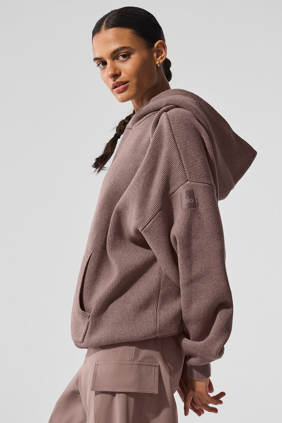 Side view showcasing the ribbed cuffs and dropped shoulders of the sweater.