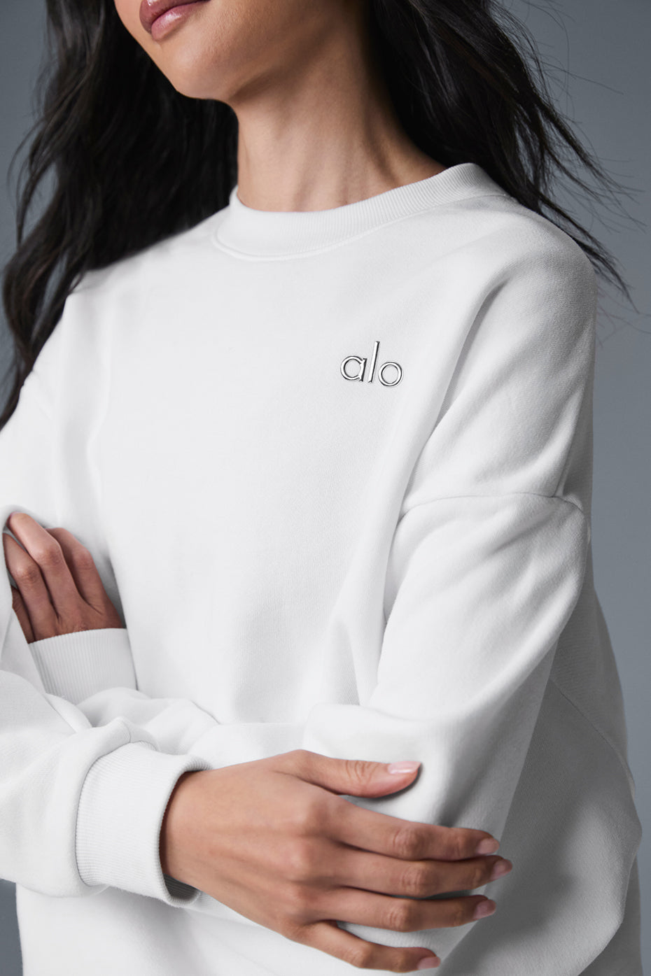 Side view of the white cashmere sweater, highlighting the ribbed cuffs and hem.