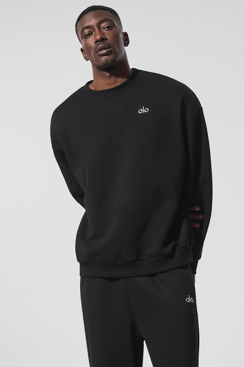 Front view of Urban Luxe black crewneck sweatshirt showcasing chrome logo.