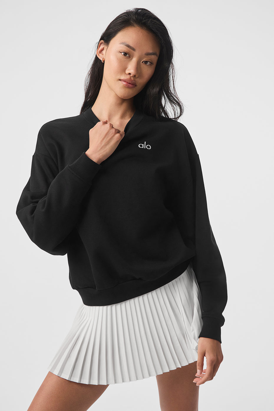Model styling the black and white sweatshirt with matching sweatpants.