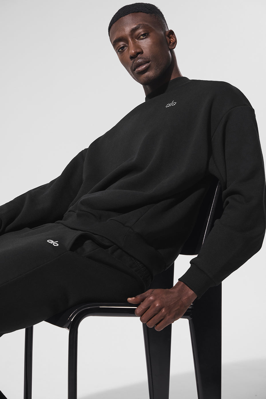 Close-up of ribbed cuffs and hem on black sweatshirt.