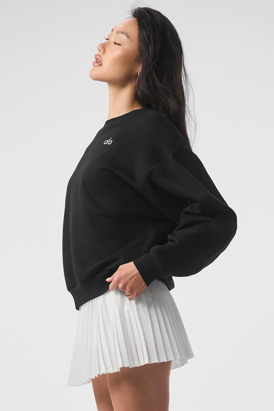 Close-up of the ribbed cuffs and hem of the black sweatshirt.