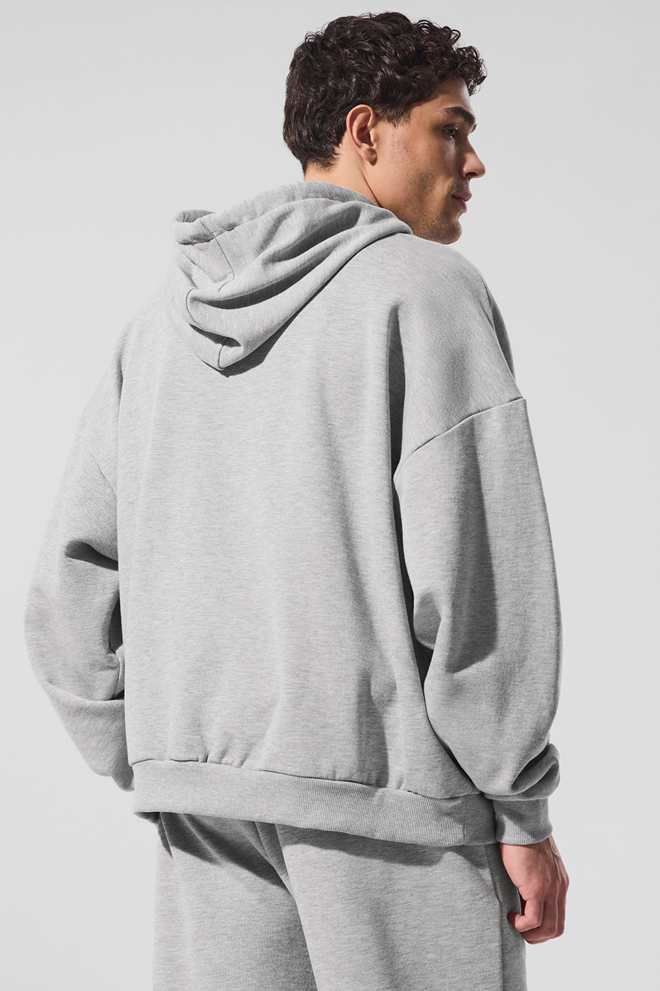 Close-up of kangaroo pocket and ribbed cuff detailing on the athletic hoodie