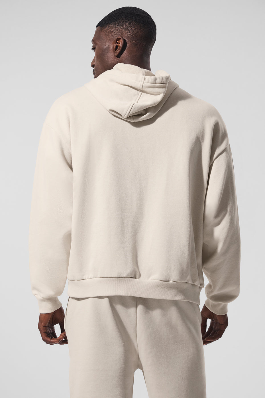 Side view of the parke sweatshirt highlighting the kangaroo pocket and ribbed cuffs.