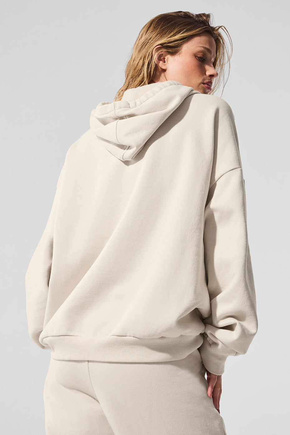 Side angle of comfort hoodie showing kangaroo pocket and ribbed cuffs