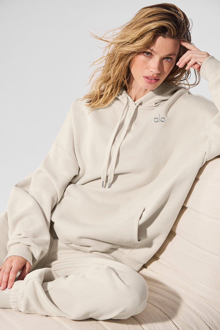 Front view of mens hoodie in bone color worn casually outdoors