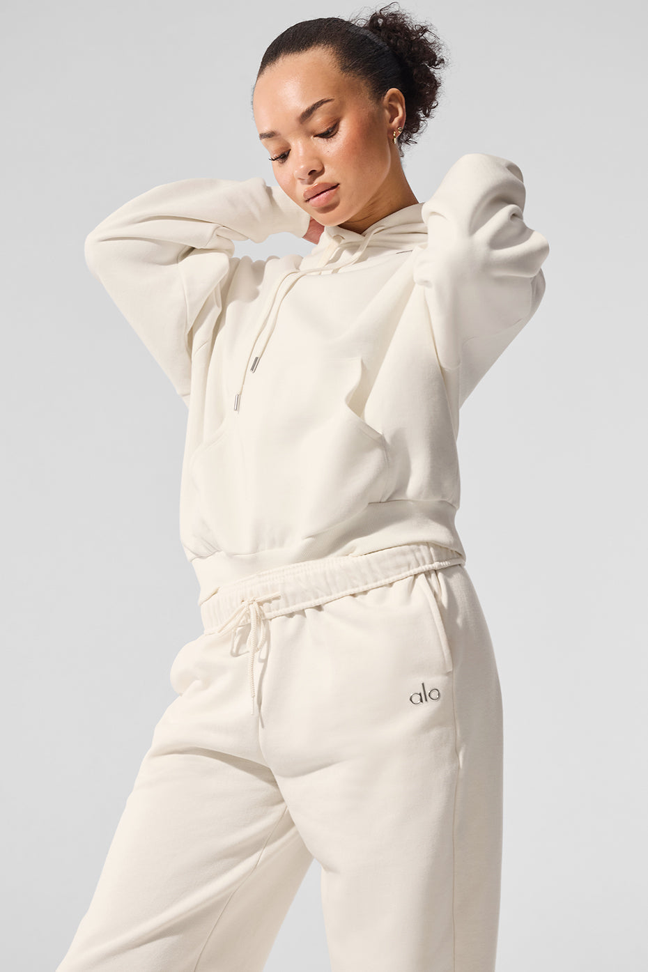 Accolade sweatshirt folded on a linen shelf, showcasing its drapey texture