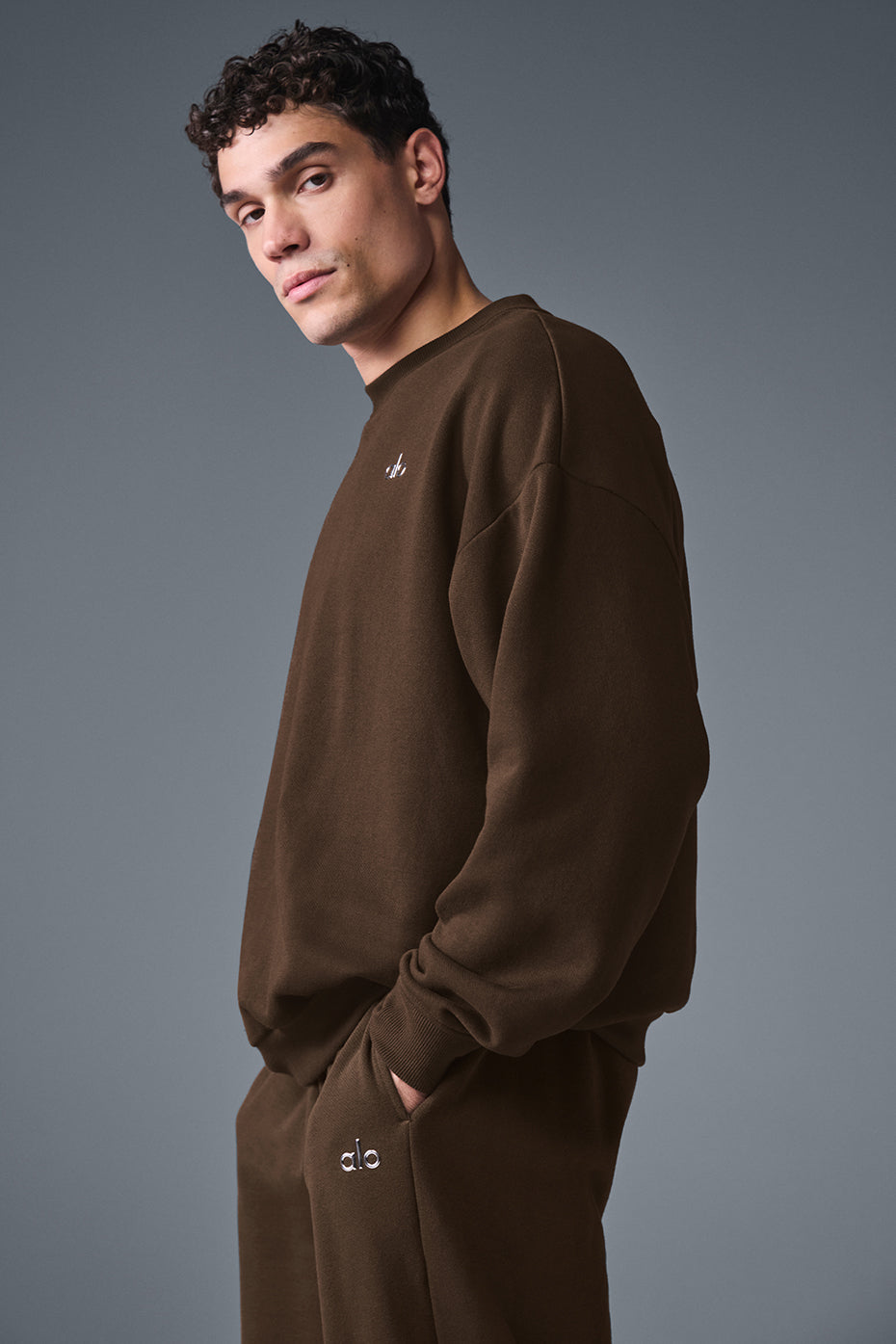 Back angle of French terry pullover styled with streetwear joggers
