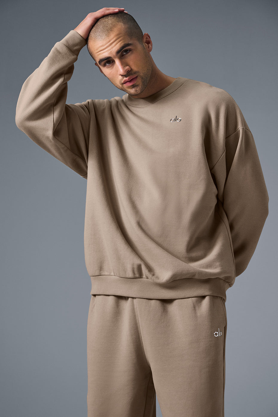 Accolade black crew neck pullover laid flat, showcasing French terry texture and logo detail.