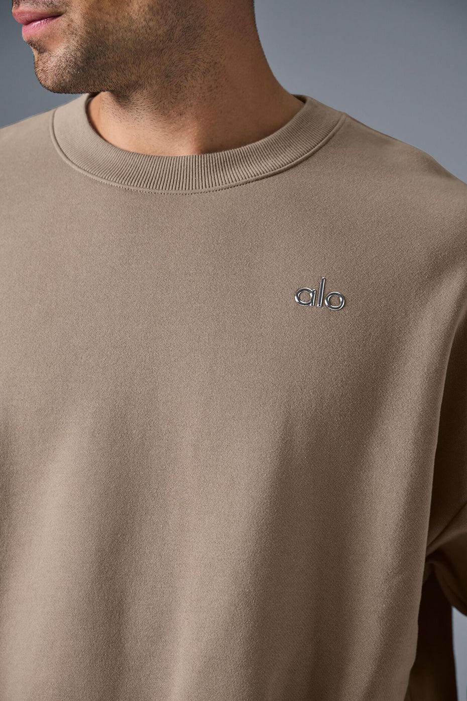 Close-up of ribbed cuffs and hem on the black streetwear sweatshirt.