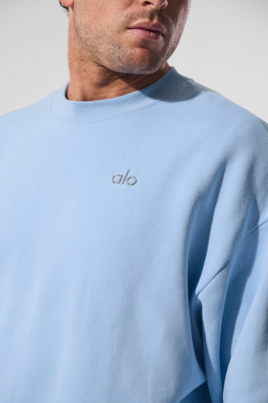 Flat lay of the Seashell Blue crew neck pullover paired with casual pants
