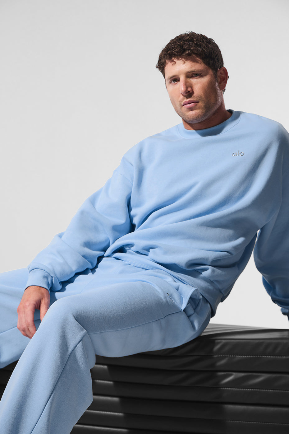 Model wearing Seashell Blue Accolade crew neck pullover with street style look
