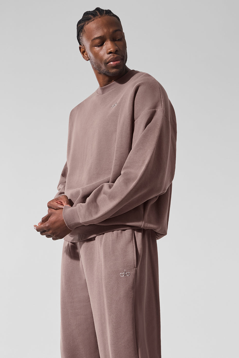 Lifestyle shot of the alo pullover paired with sweatpants, ideal for a casual day out.