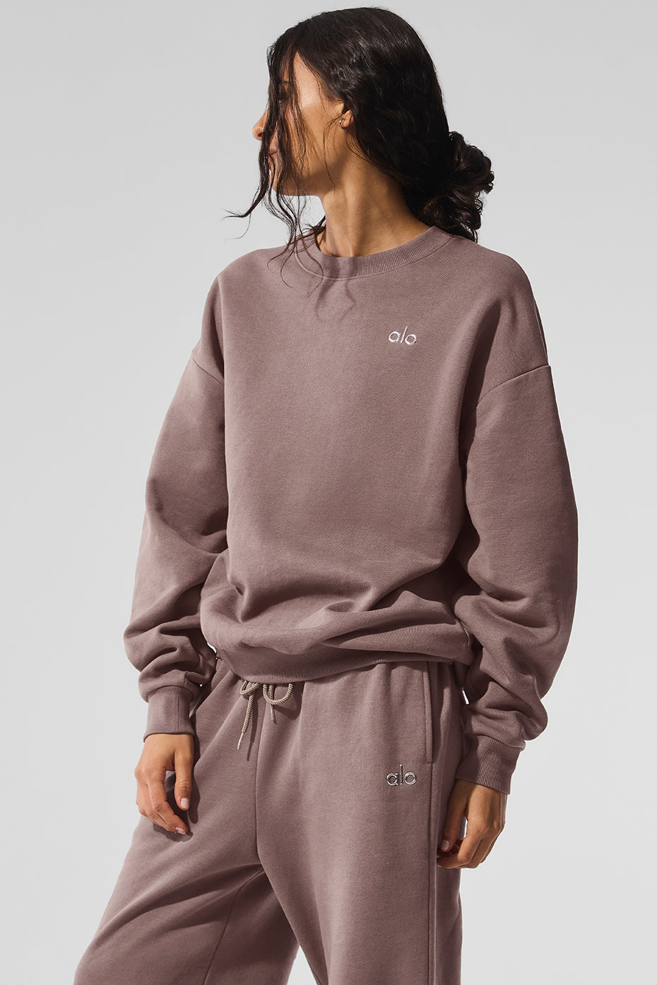Neutral sweatshirt folded on a wooden bench