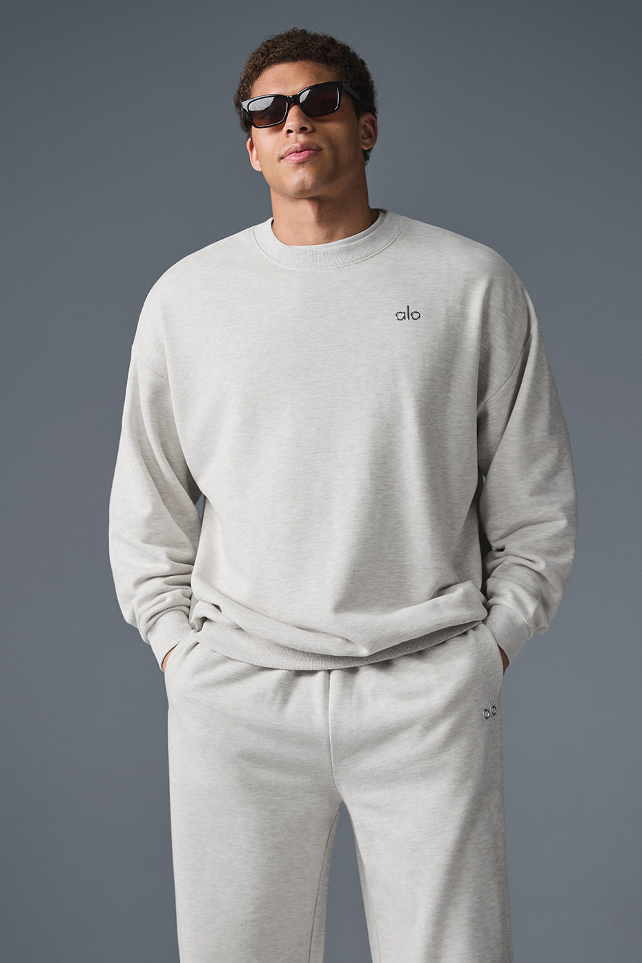 Close-up of the white Heather crewneck pullover showing ribbed cuffs and hem