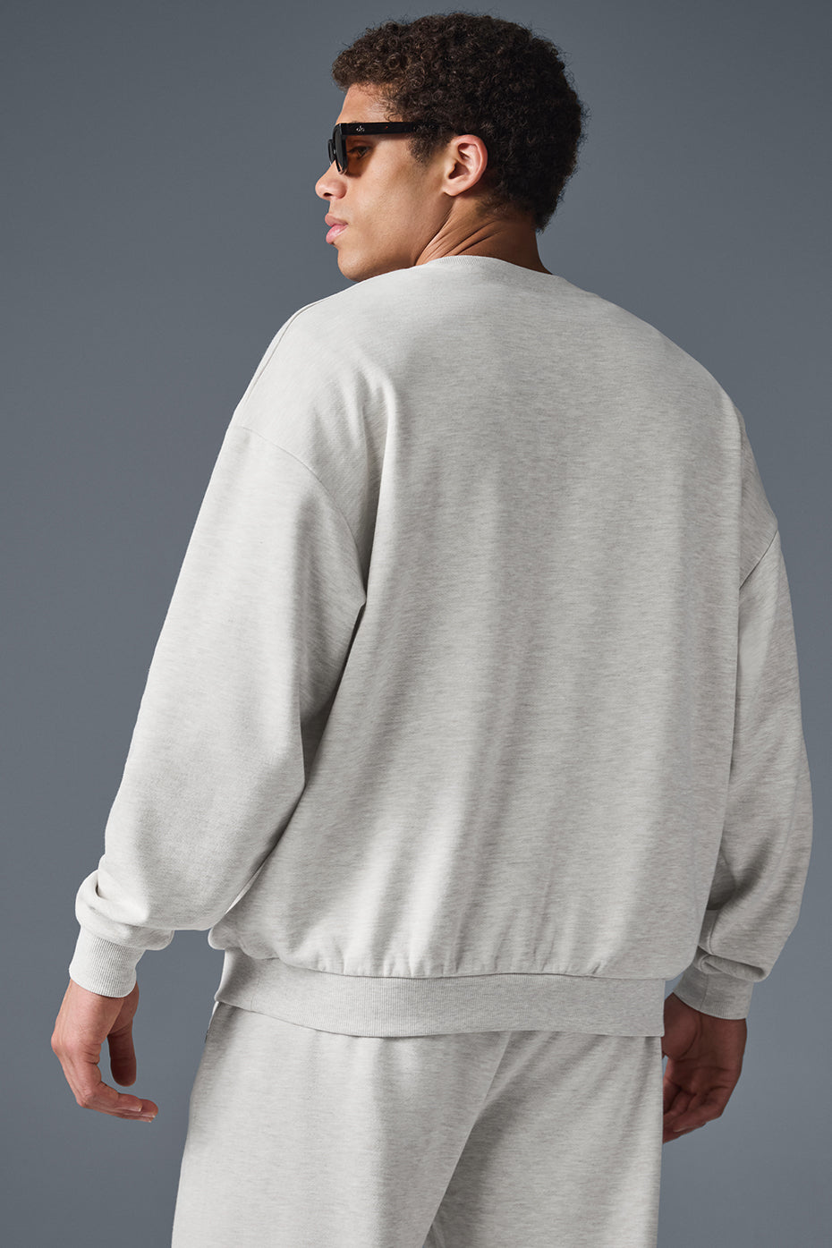 Detail of the chrome ALO logo on the cozy French terry pullover