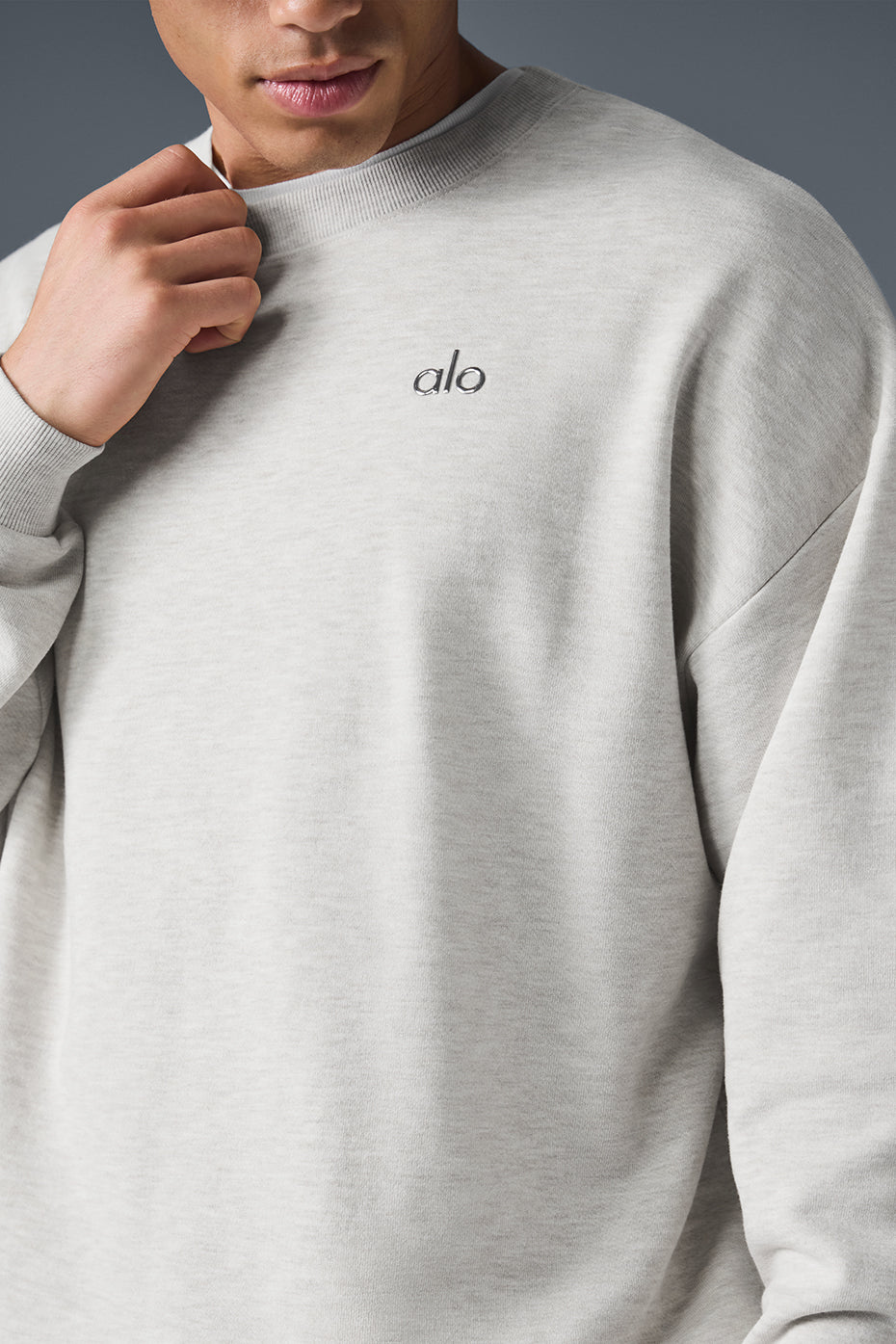 Close-up of the white Heather crewneck pullover showing ribbed cuffs and hem