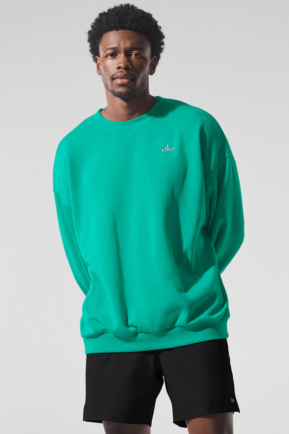 Front view of the Accolade crew neck pullover in spruce green, highlighting its classic design.