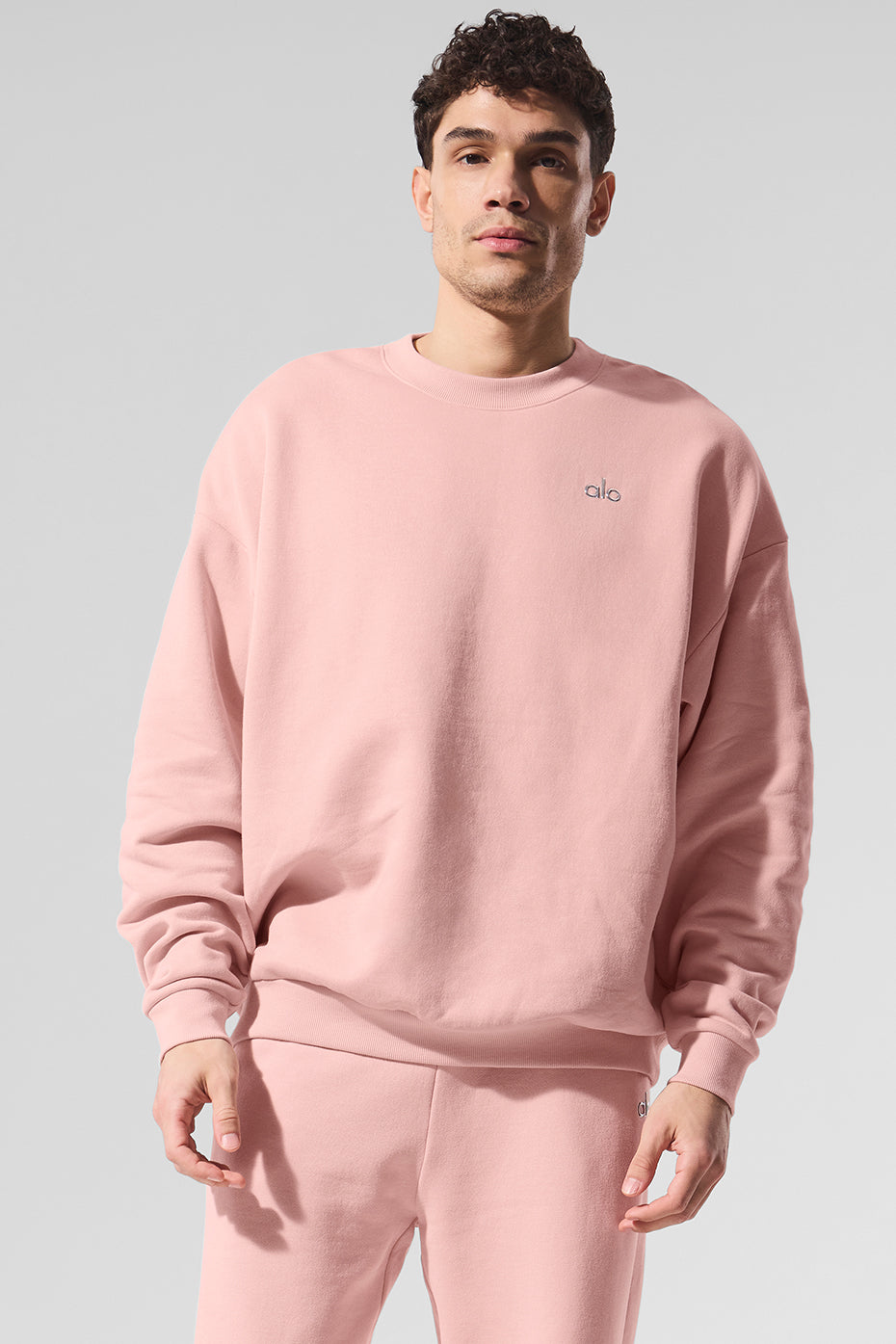Woman relaxing in pink quartz French terry sweatshirt outdoors