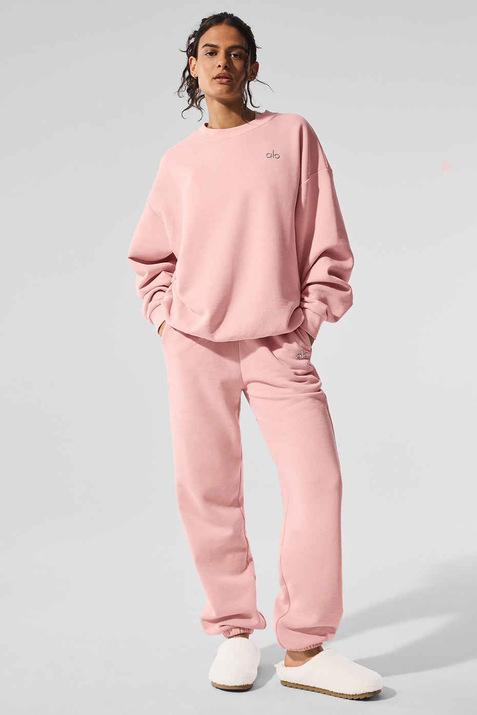 Side view of the black crew neck pullover, highlighting the ribbed cuffs and hem.