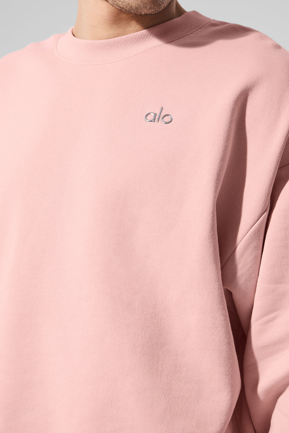 Styled pink quartz sweatshirt paired with jeans for a casual look