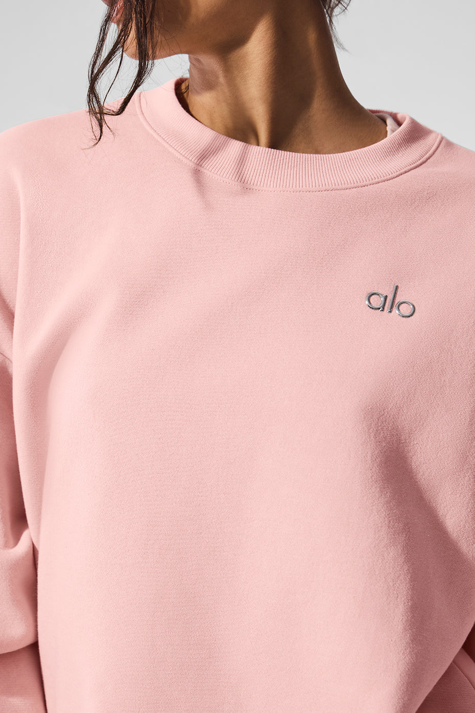 Side view of the black crew neck pullover, highlighting the ribbed cuffs and hem.