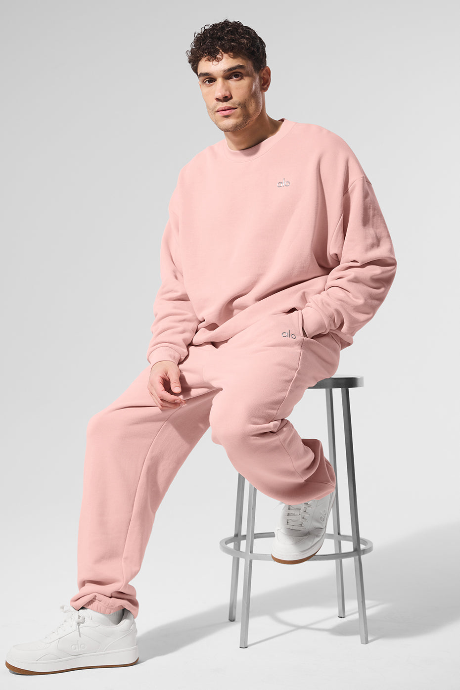 Close-up of pink quartz crew neck pullover showing ribbed cuffs and neckline