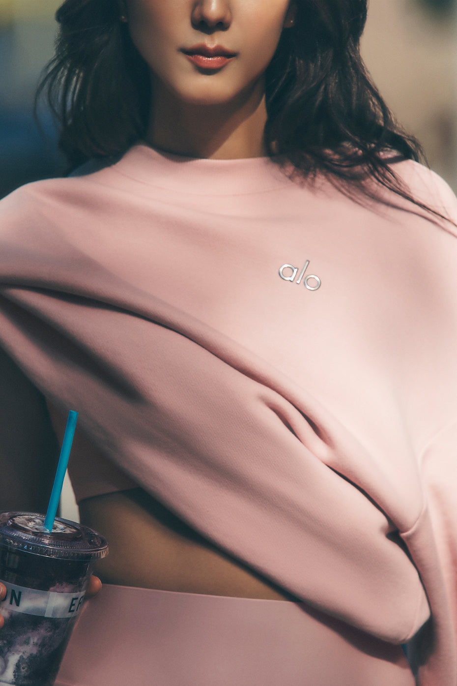 Front view of the pink quartz Accolade crew neck pullover, showcasing its relaxed fit.