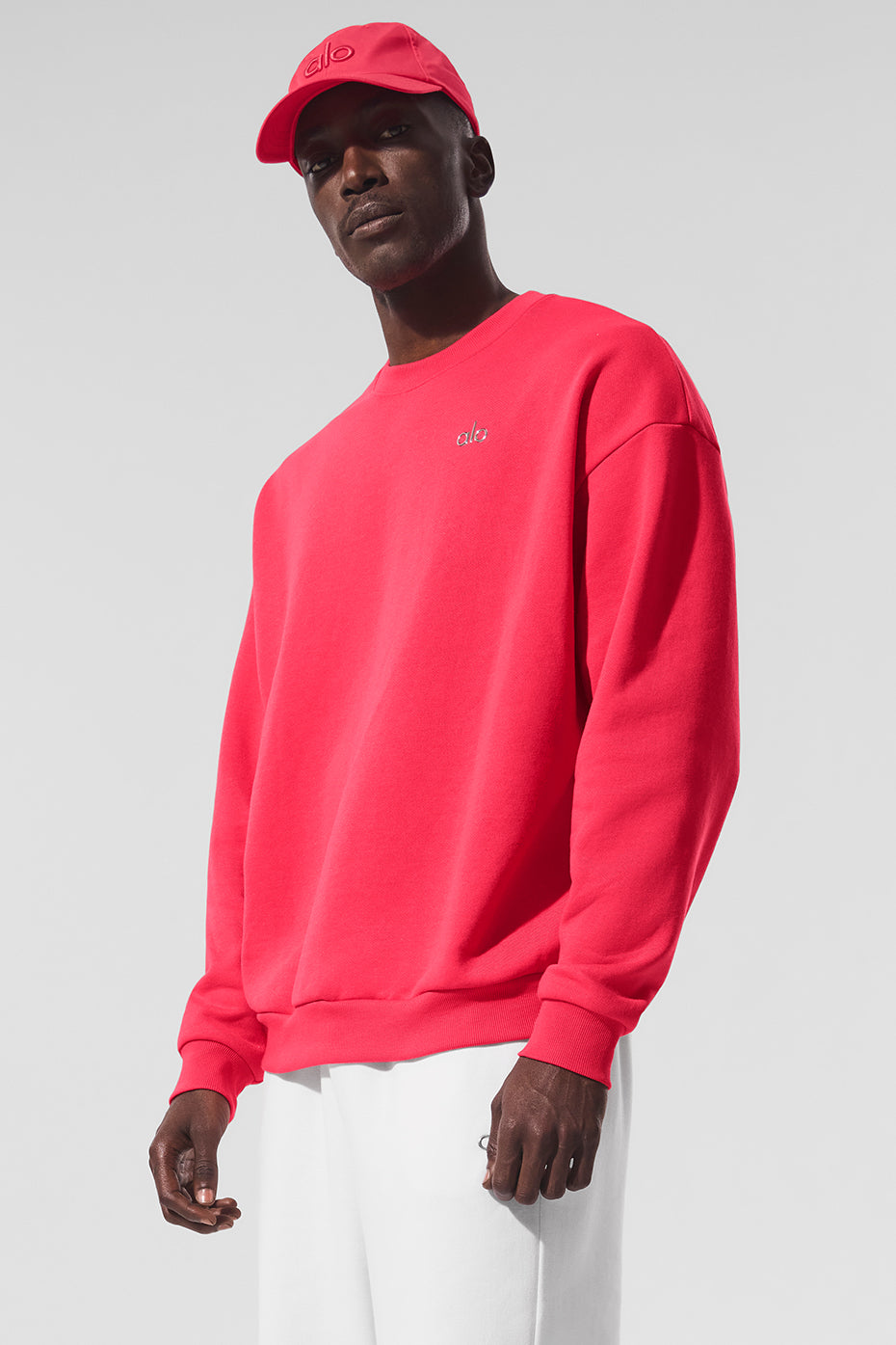 Close-up of the Acclaimed Crew Neck Pullover in vibrant red, showcasing the ALO logo.
