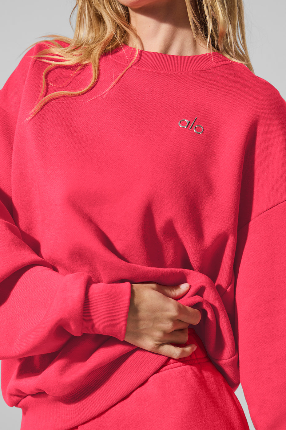 Close-up of the ribbed cuffs and hem on the black crew neck pullover.