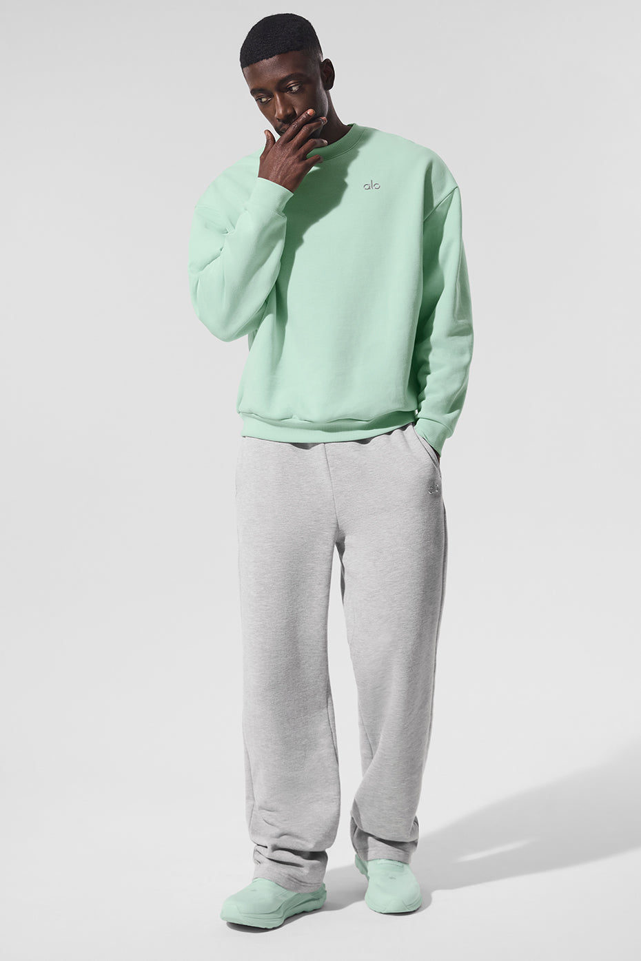 Front view of the spearmint Accolade crew neck pullover styled with jeans.
