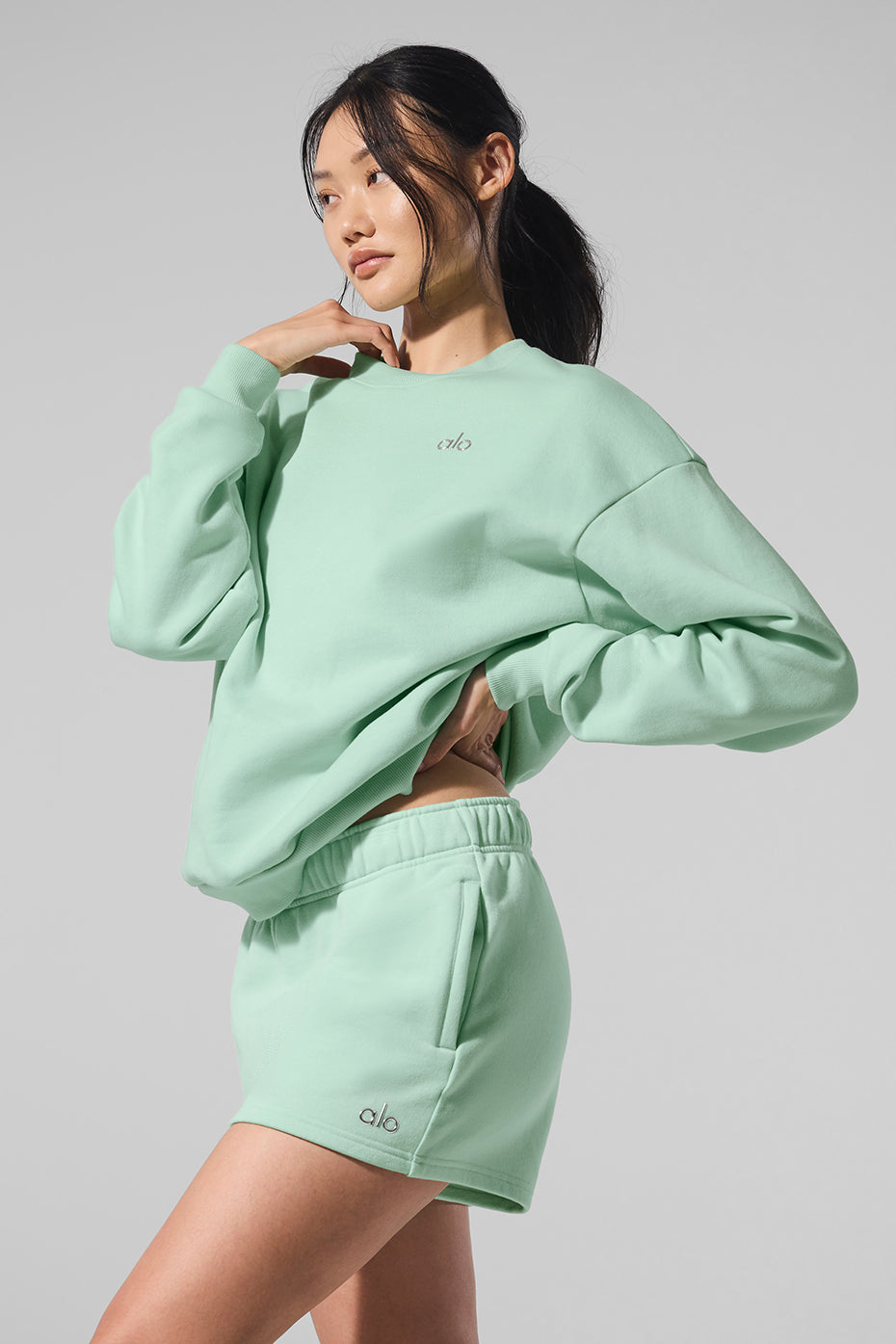 Front view of womens black crew neck pullover in a relaxed setting.