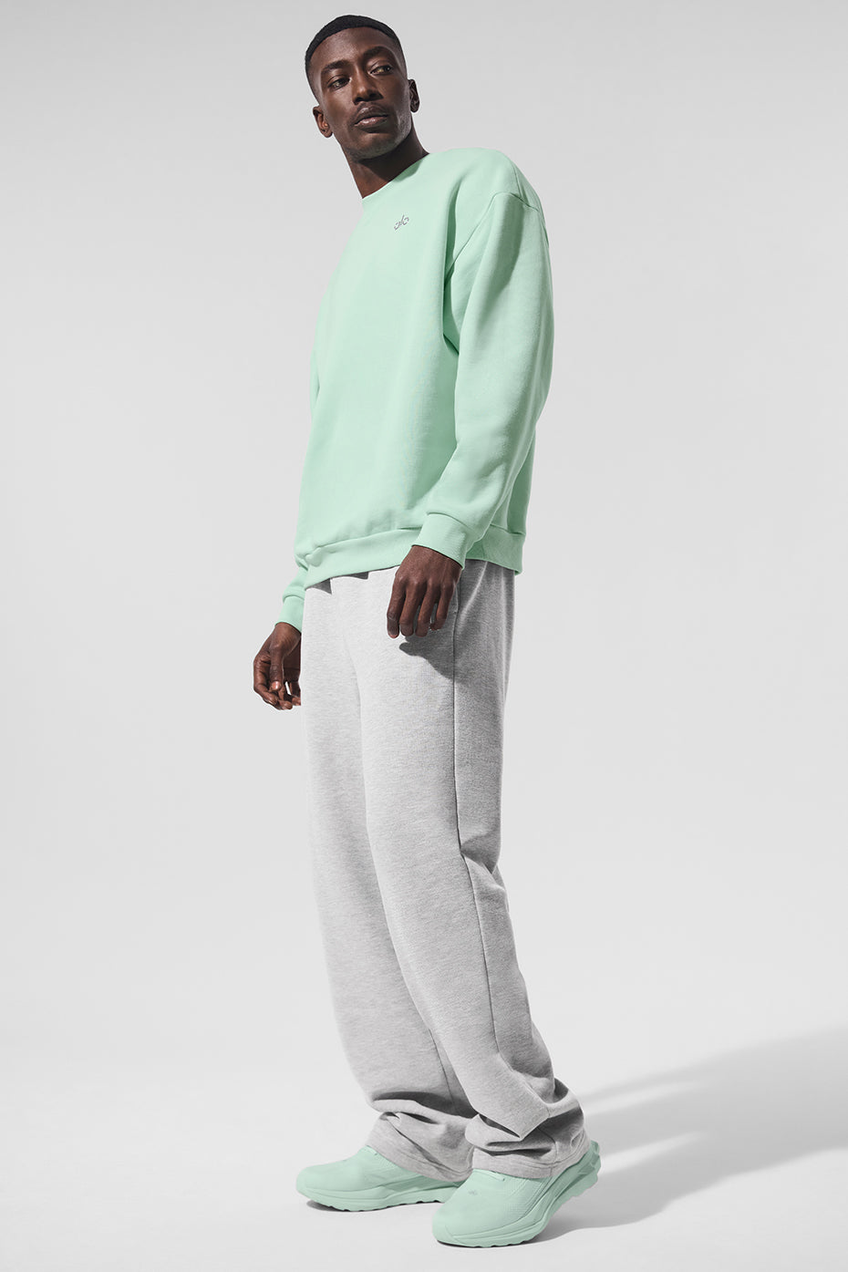 Close-up of the ALO logo on the chest of the crew neck pullover.