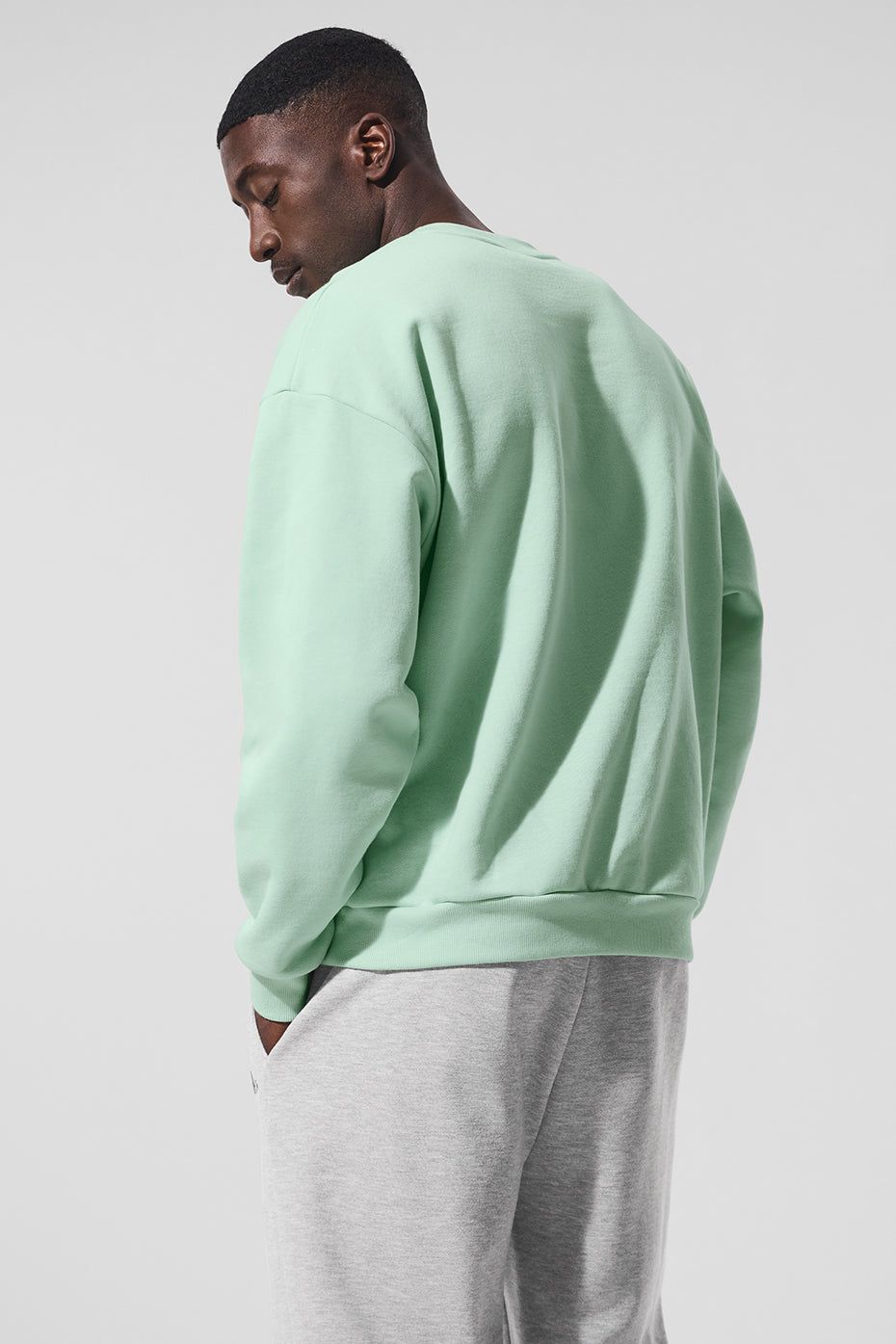 Back view showcasing the relaxed fit of the spearmint pullover.