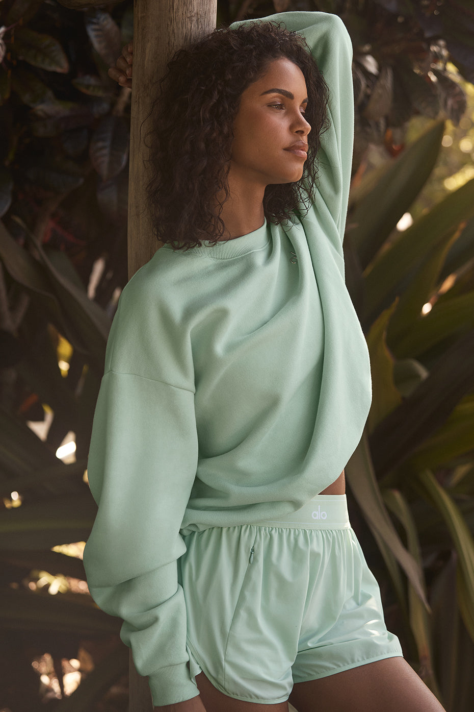 Front view of women's black crew neck pullover in a relaxed setting.