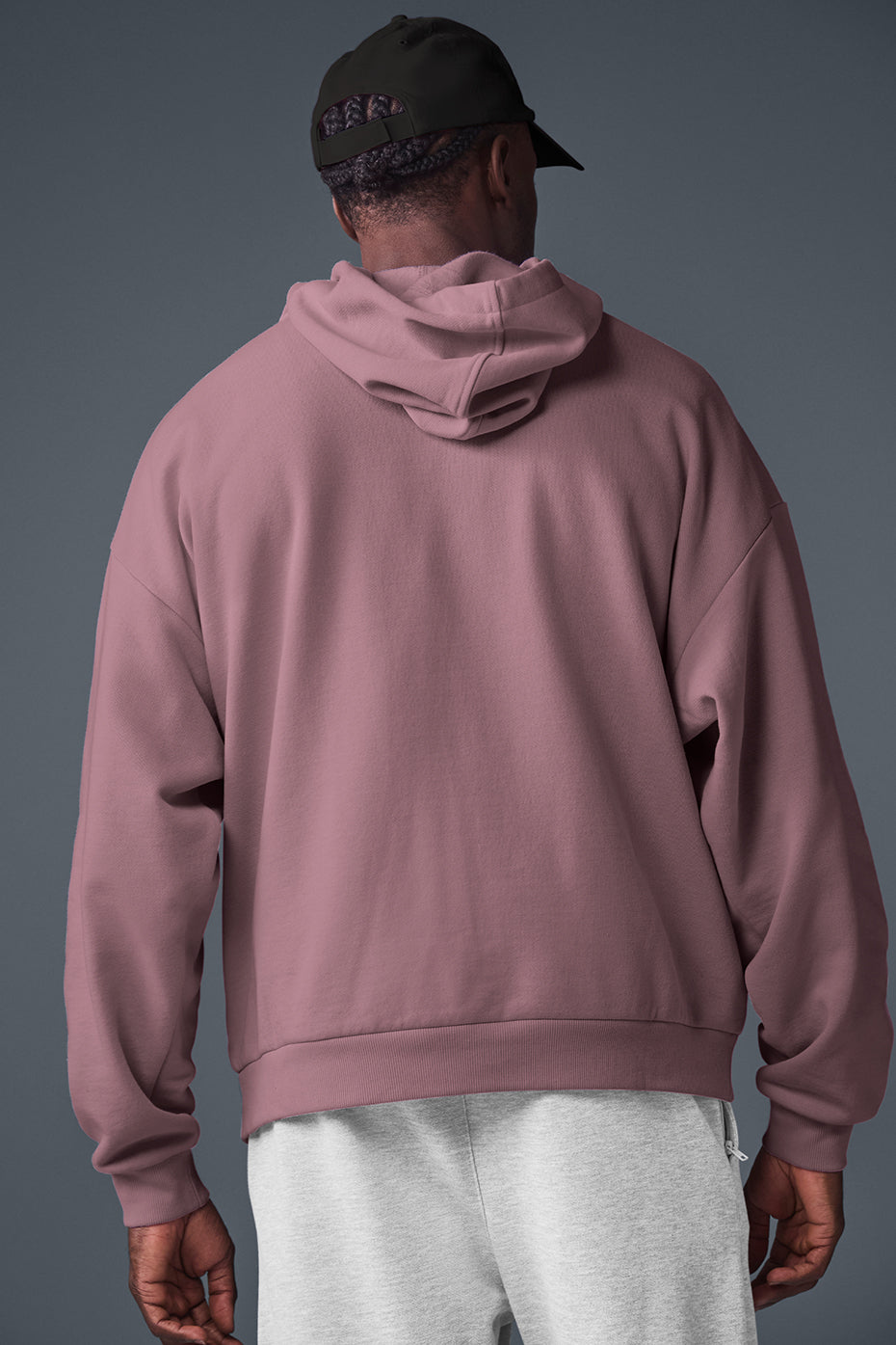 Side view of the Accolade hoodie, highlighting the kangaroo pocket and ribbed cuffs.