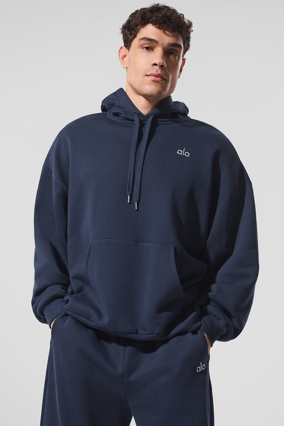 Front view of navy hoodie styled with matching sweats for athleisure wear