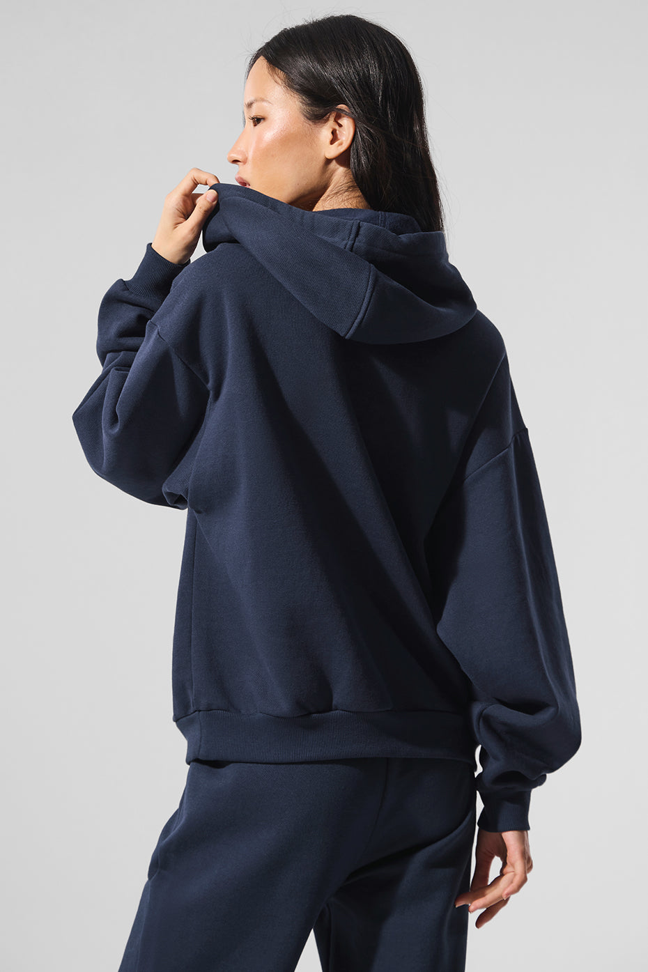 Model wearing comfort hoodie from side profile in soft natural lighting