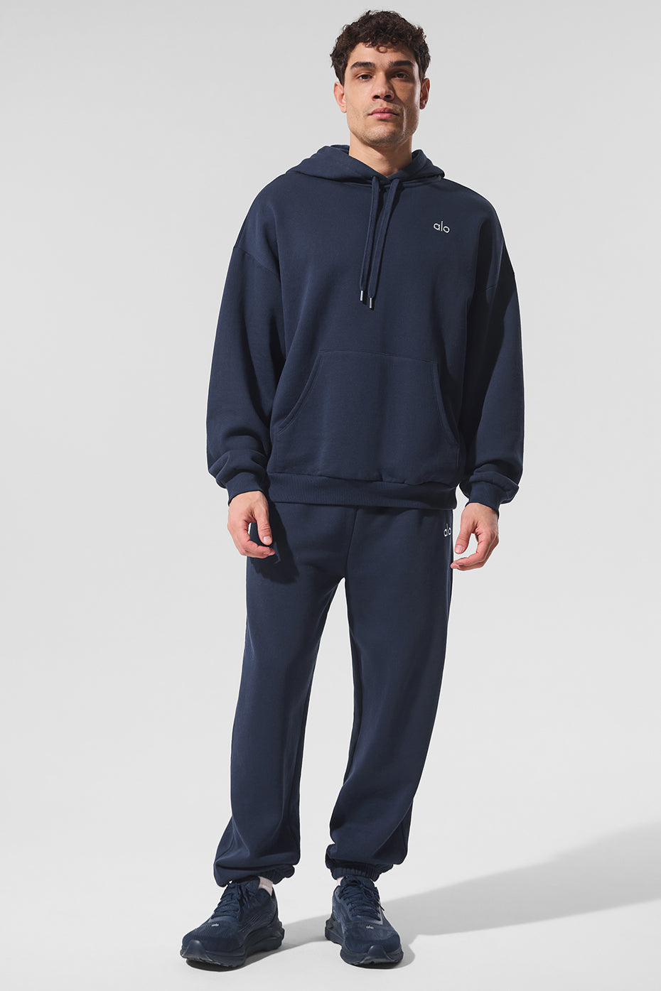 Front view of navy hoodie styled with matching sweats for athleisure wear