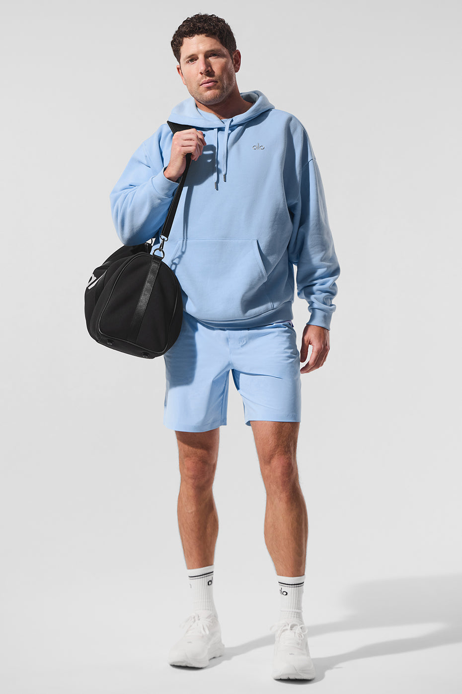Model wearing Seashell Blue hoodie in urban setting