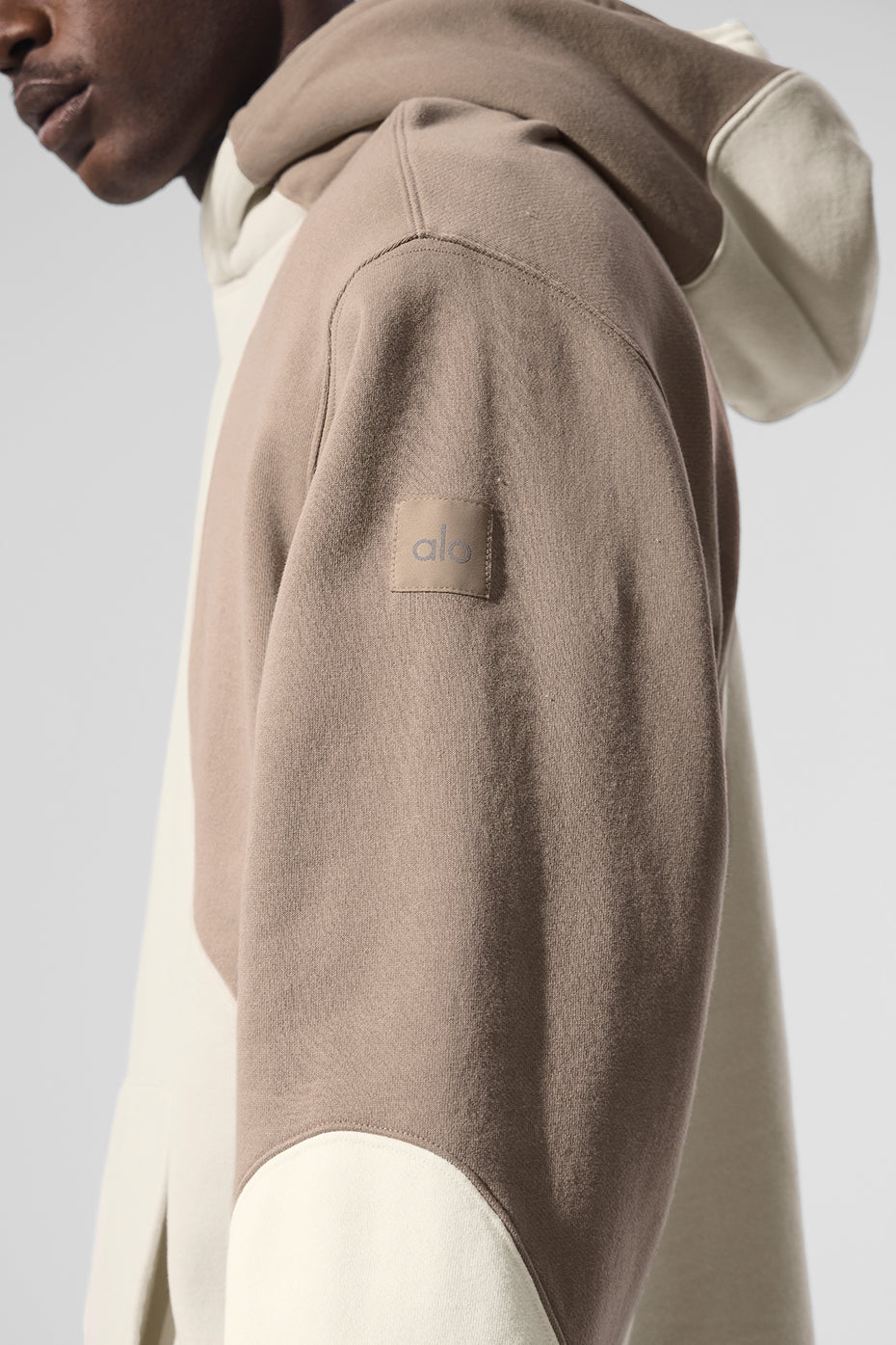 Back view of parke sweatshirt worn with matching joggers near a cozy cabin in Vermont