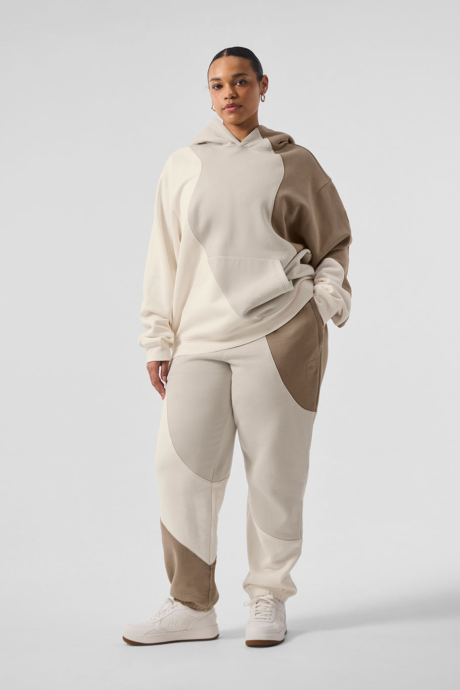 Close-up of the Wave Embrace oversized hoodie showcasing the seamed wave pattern.