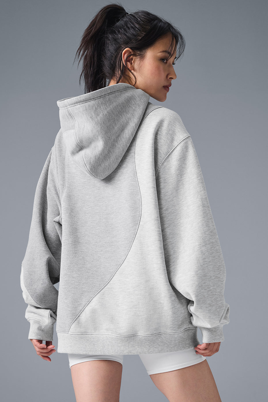 Model wearing a loose-fit hoodie for casual street style